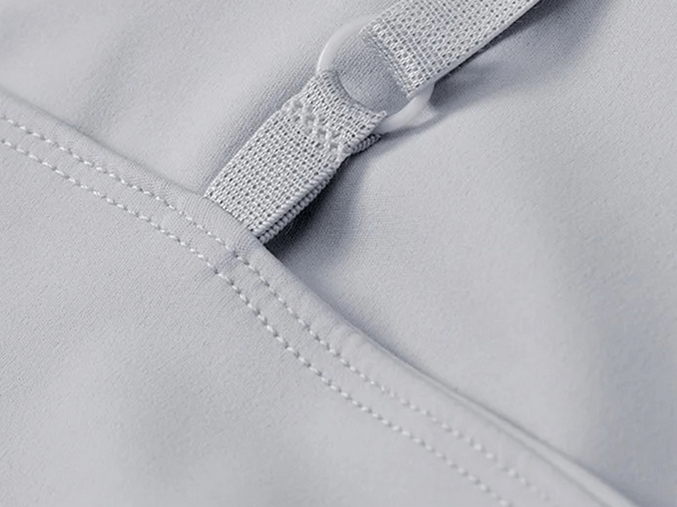 Close-up of breathable spandex material in women's workout set, showcasing stitching and fabric texture for SF2120 top and leggings.